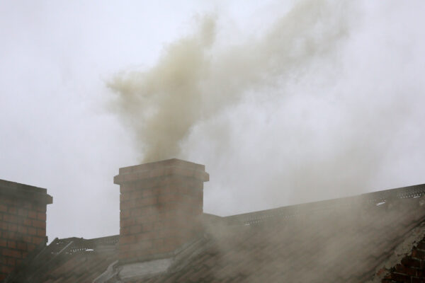 Smoke exits the chimney of a house in England